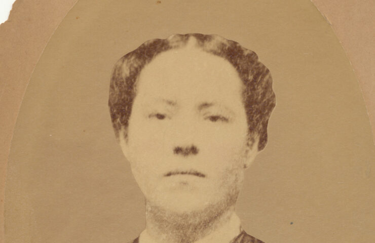 Mary Parker in sepia, wearing a false-yoke style shirt and white collar. Her hair is pinned back.